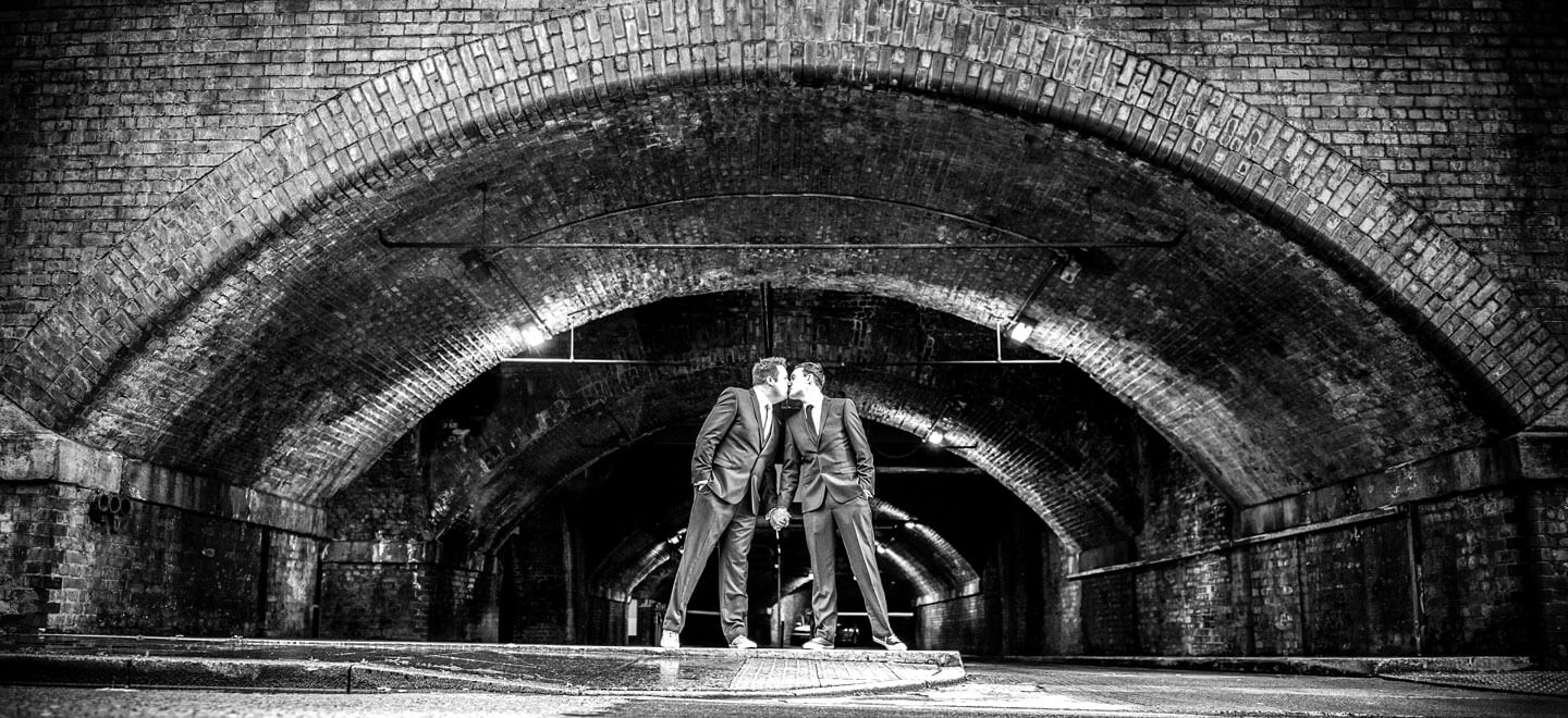 Neil and Ryan kissing under bridge by James Tracey gay wedding photography via the gay wedding guide 6