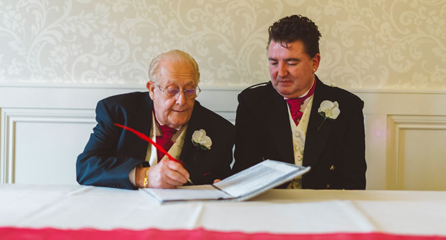 Signing the register Vince and Georges gay wedding Berkshire photographed by gay wedding photographer Benjamin Stuart Photography 3 5