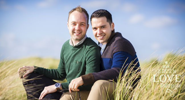 Sitting in the sand banks Neil and Rumen gay engagement shoot by It Must Be Love Weddings Photographer Hampshire via the Gay Wedding Guide 3 4