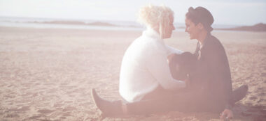 Sun Drenched Sitting On Beach With Dog Emily And Amy Engagement Photography And Copyright Mrs Jutson Photography Via The Gay Wedding Guide 3 4 380X174