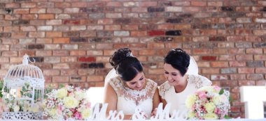 Two Brides Sitting At Wedding Table At Hilton Chester Country House Wedding Venue Cheshire Gay Wedding Guide 9 380X174