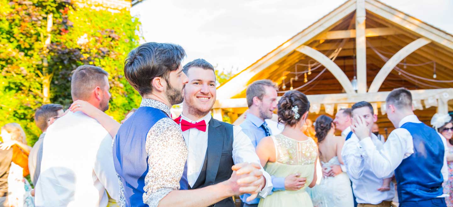 Two Grooms dancing at Balmer Lawn Gay wedding venue Brockenhurst via the Gay Wedding Guide 9