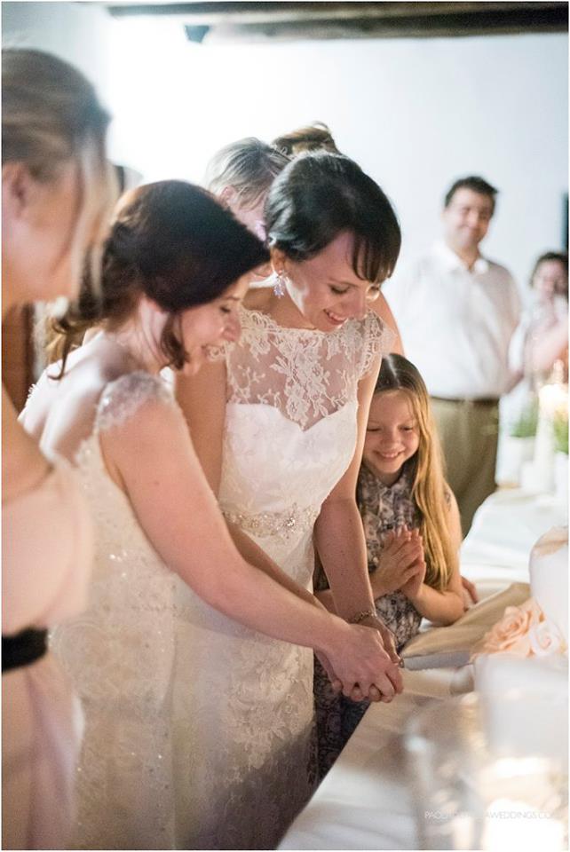 cutting the cake at lesbian destination wedding of Sara and Karen photograph by Paola de Paola Photography 3 5