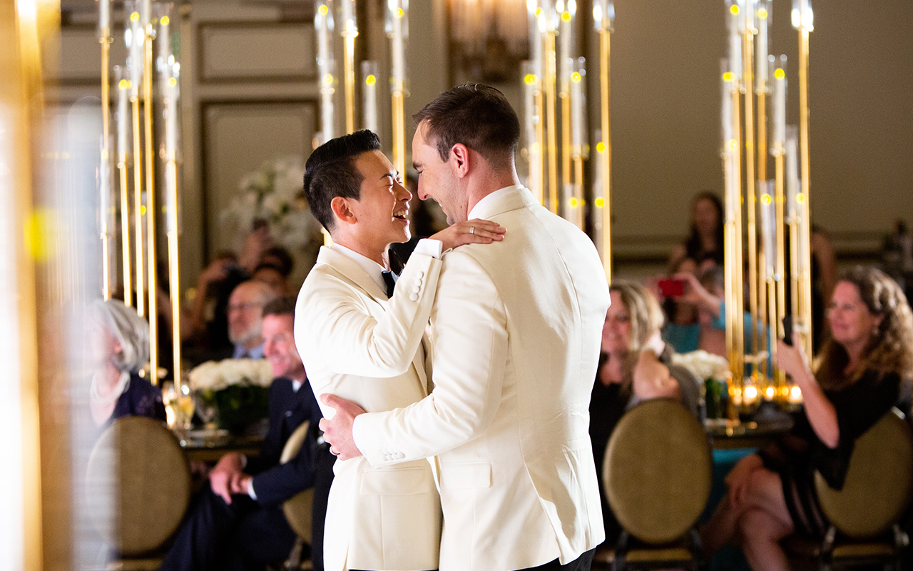 derrick and michael dancing and laughing close together at their gay wedding party 3 5