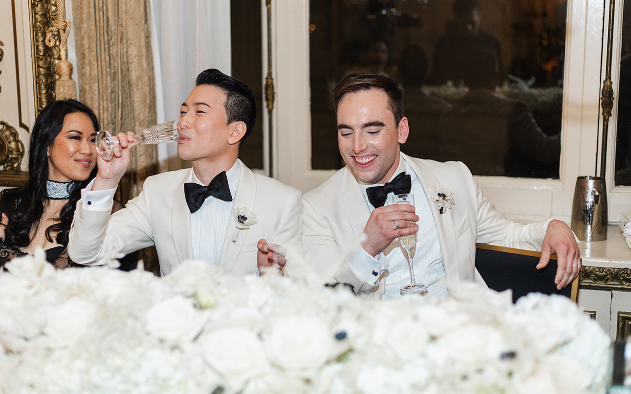 derrick and michael sip champagne at their gay wedding party 3 5