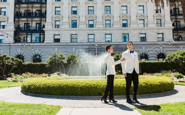 Derrick Touching Michael Arm By The Fountain 5 368X229