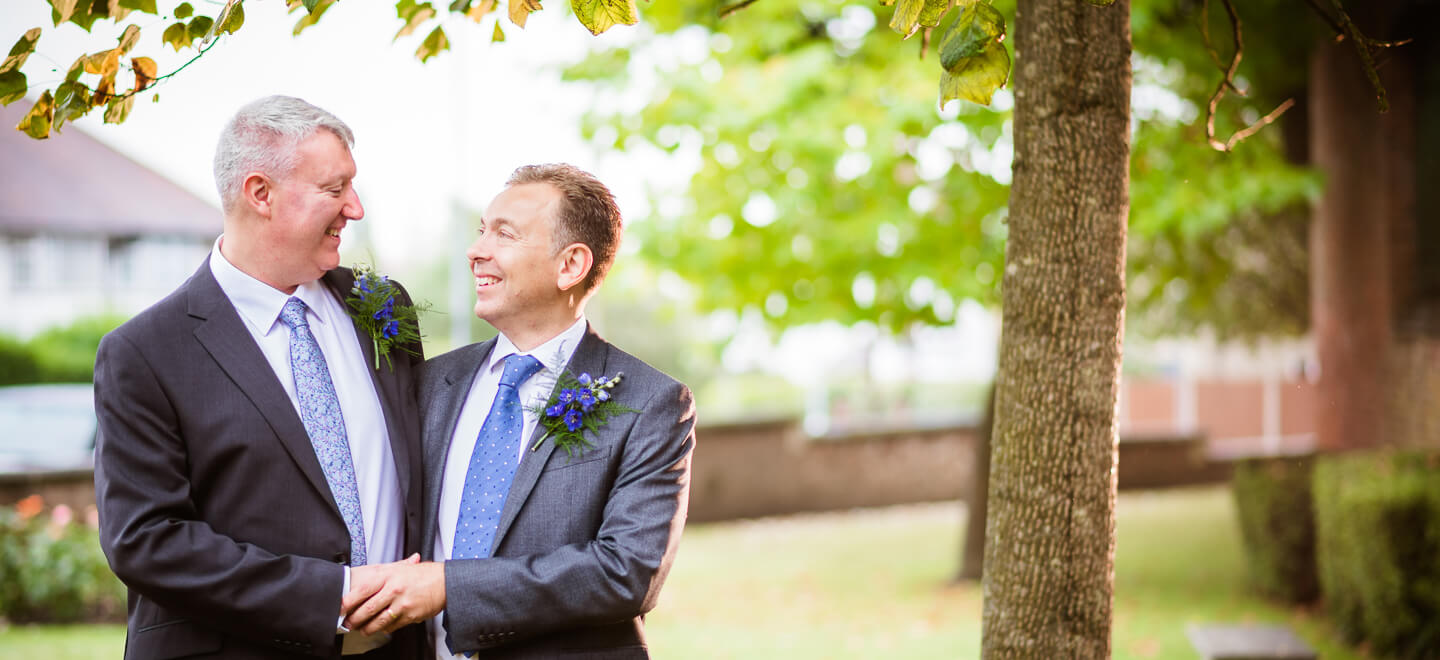 gay grooms under tree image by Pike Photography via gay wedding guide 6