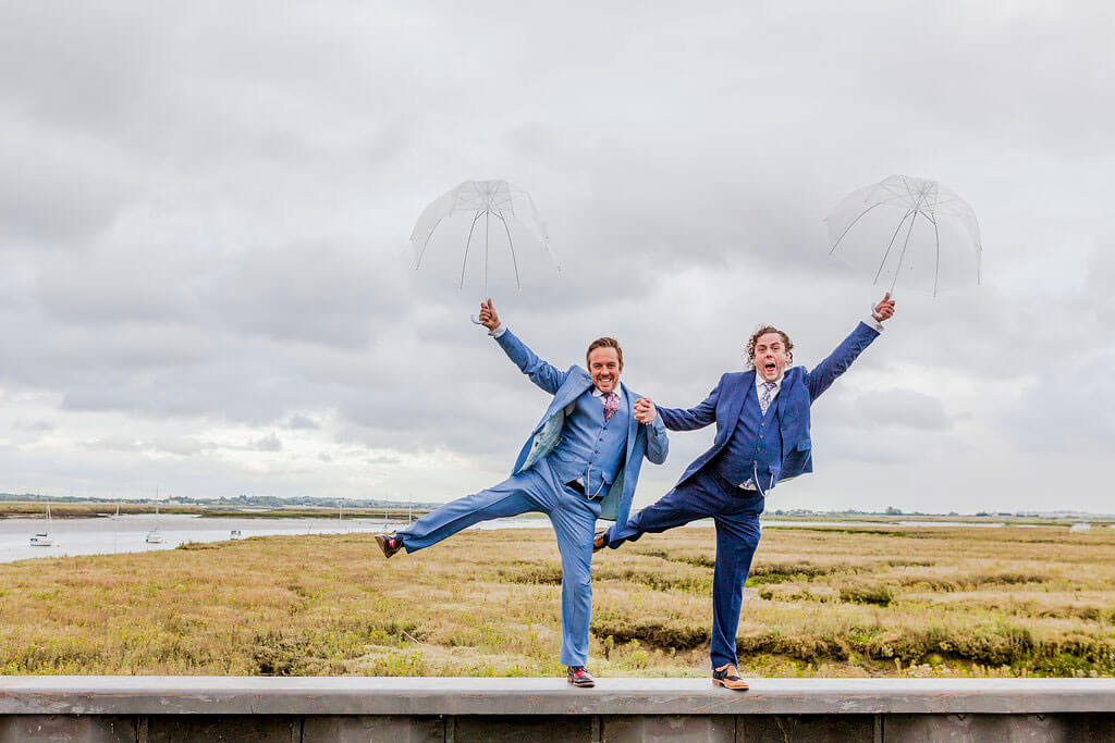 happy holding umbrellas Real Gay Wedding of Shaun and Carl via The Gay Wedding Guide images by Ross Willsher 3 5