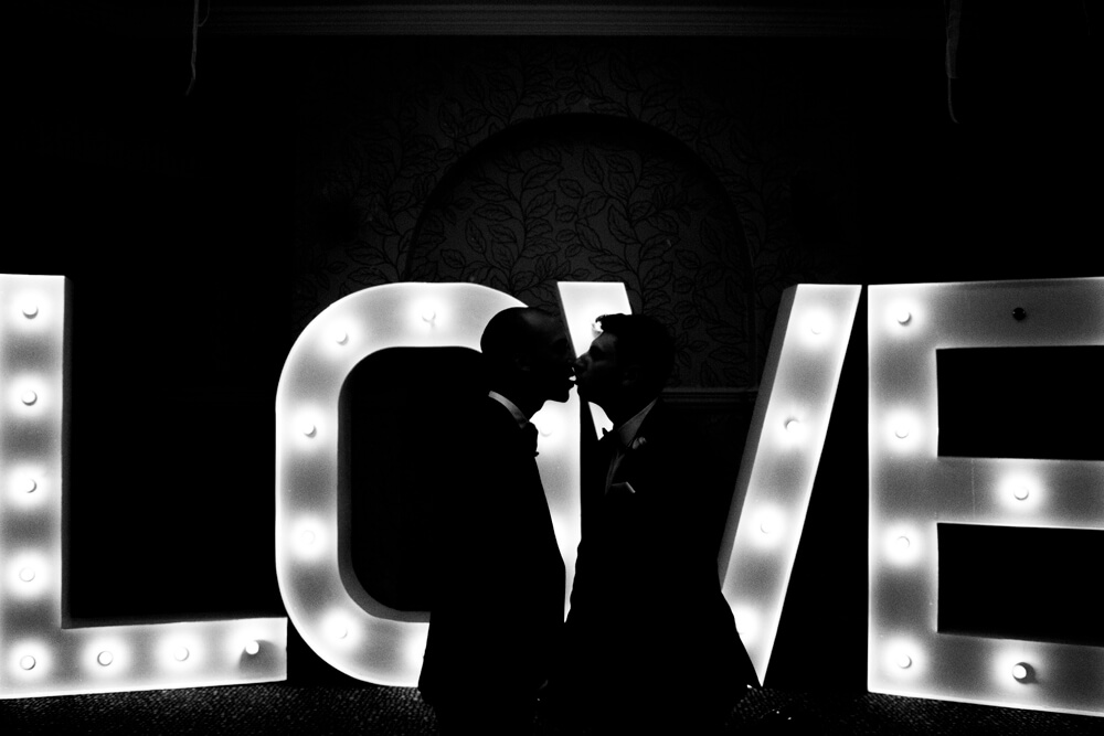 kiss by love lights at real gay wedding of Martin and Grey copyright Jennifer Langridge 3 5