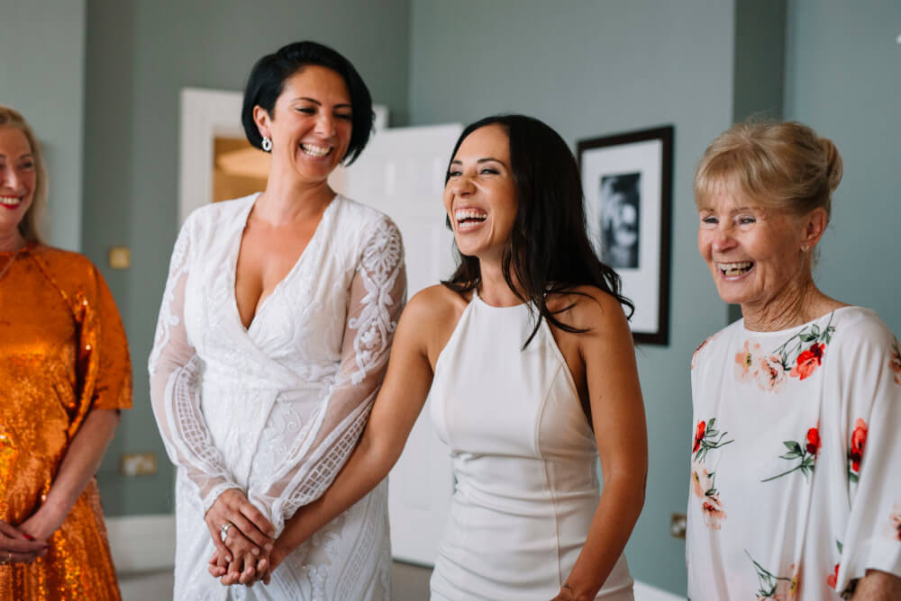 laughing Suria and Paige lesbian wedding The Grand Brighton image by In Between Days 1 5