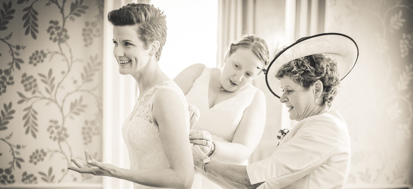 lesbian bride getting ready with help image by lesbian wedding photography Pike Photography via gay wedding guide 6