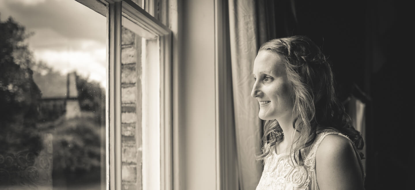 lesbian bride looks out of window image by lesbian wedding photography Pike Photography via gay wedding guide 6