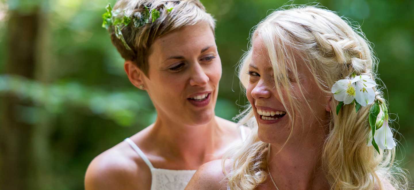 lesbian brides in forest closeup at lesbian wedding photographer Liz O Malley Gay Wedding Guide 2