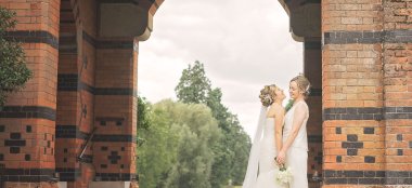 Lesbian Brides Under Arch At The Elvetham Hotel Wedding Venue Hampshire Gay Wedding Guide 9 380X174