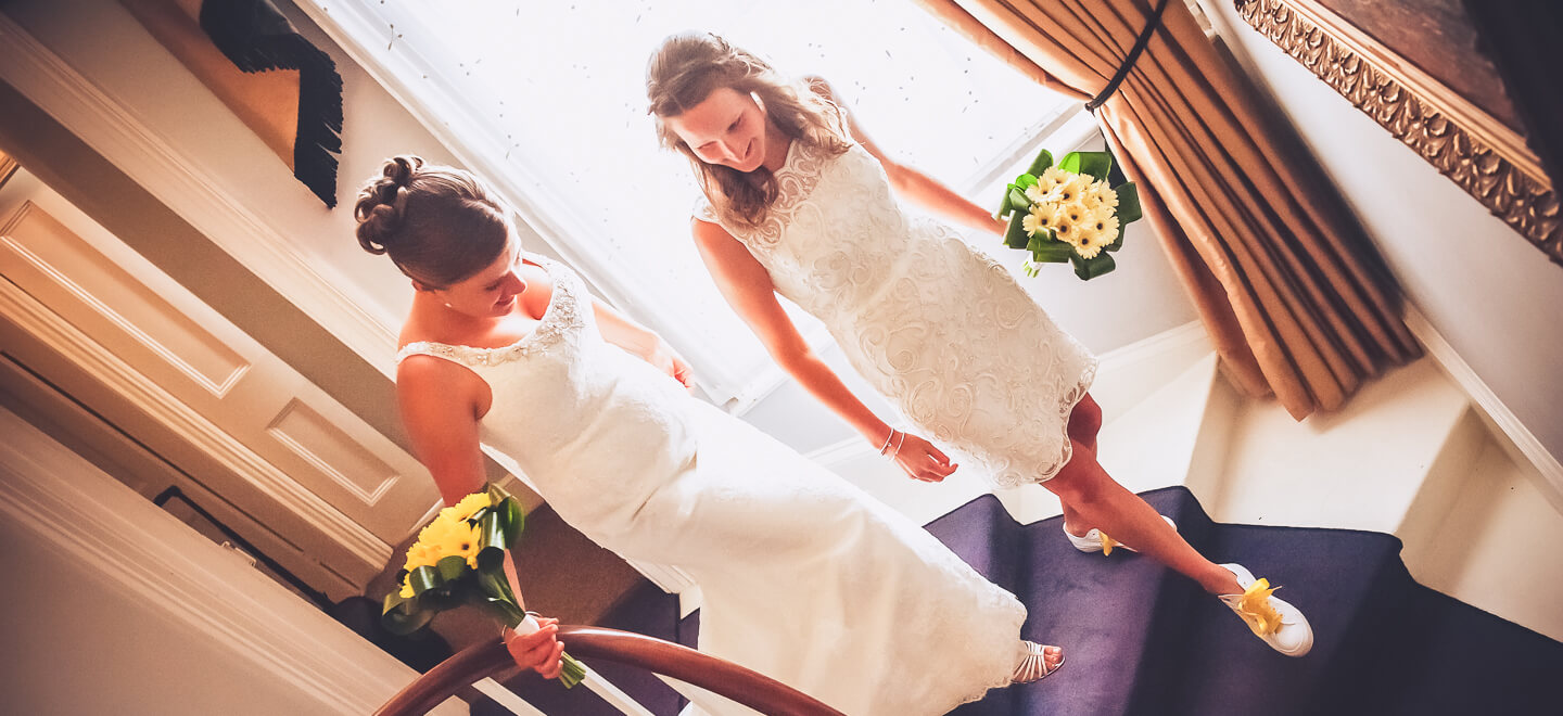 lesbian brides walk down the stairs image by lesbian wedding photography Pike Photography via gay wedding guide 6