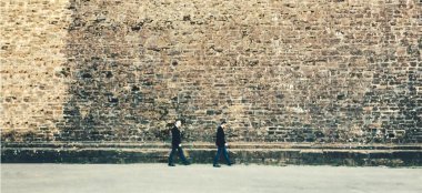 Orchestra Weddings Gay Couple Walking By A Big Wall 6 380X174