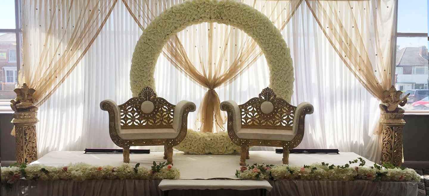 two chairs and flower arch at DIY wedding Leicester Holiday Inn Leicester gay wedding guide 9