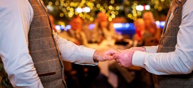 Two Gay Grooms Holding Hands At Oec In Sheffield Via Gay Wedding Guide 9 380X174
