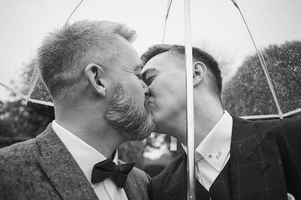 umbrella kiss at gay wedding of Rory and Colin image by Hoult Photography via Gay Wedding Guide 1 5