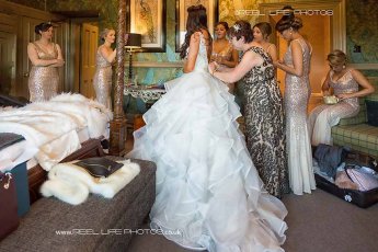 Bride Being Helped Into Her Wedding Dress Reel Life Photos Sswg 345X230