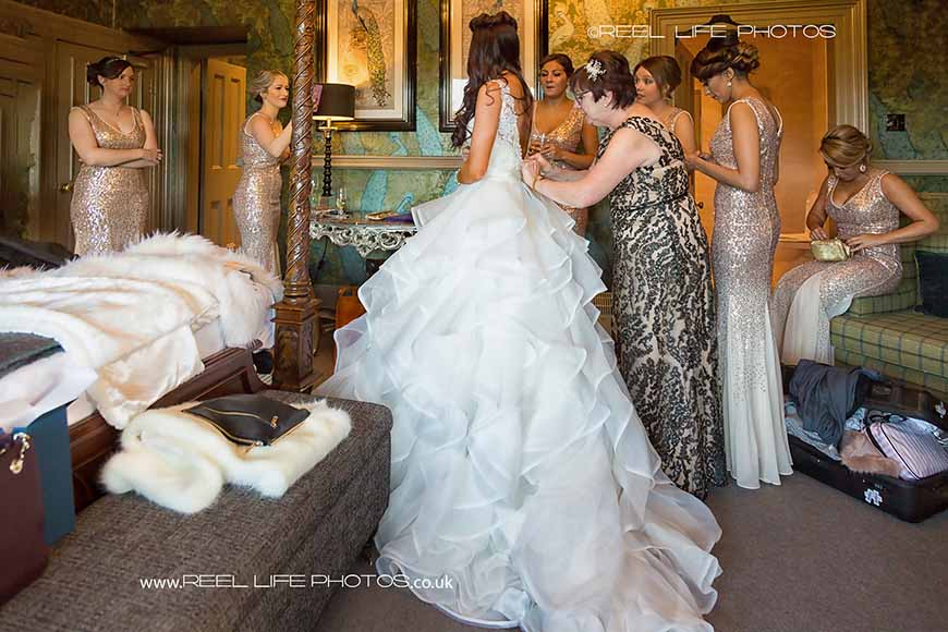 bride being helped into her wedding dress reel life photos sswg