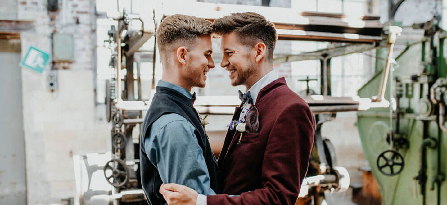 1440 Grooms embrace at styeld gay wedding shoot at Germany fabric factory. Image by JuliaBartelt 1