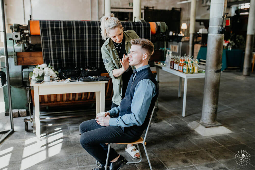 Groom gets makeup at styled gay wedding shoot at Germany fabric factory.1 Image by JuliaBartelt 1 5