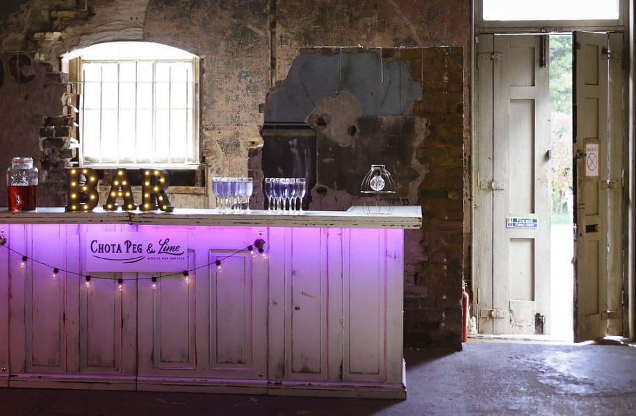 Purple lighting at bar at Gothic and Purple wedding ideas Styled Shoot via The Gay Wedding Guide 1 5