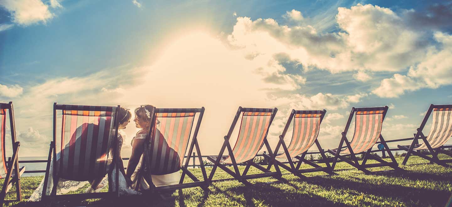 Lsebian Brides In Deck Chairs At Ocean Kave Unique Wedding Venue Devon Image Via The Gay Wedding Guide 1 - Uwp - Profile Lsebian Brides In Deck Chairs At Ocean Kave Unique Wedding Venue Devon Image Via The Gay Wedding Guide 1 - Uwp - Profile Gay Wedding Guide