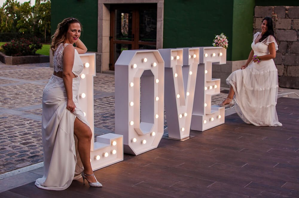 Posing By Love Sign Styled Lesbian Wedding Elopment Of Fatima And Rebeca Hug Image Fotografiando La Vida Via Gay Wedding Guide 2 - A Spanish Elopement Posing By Love Sign Styled Lesbian Wedding Elopment Of Fatima And Rebeca Hug Image Fotografiando La Vida Via Gay Wedding Guide 2 - A Spanish Elopement Gay Wedding Guide