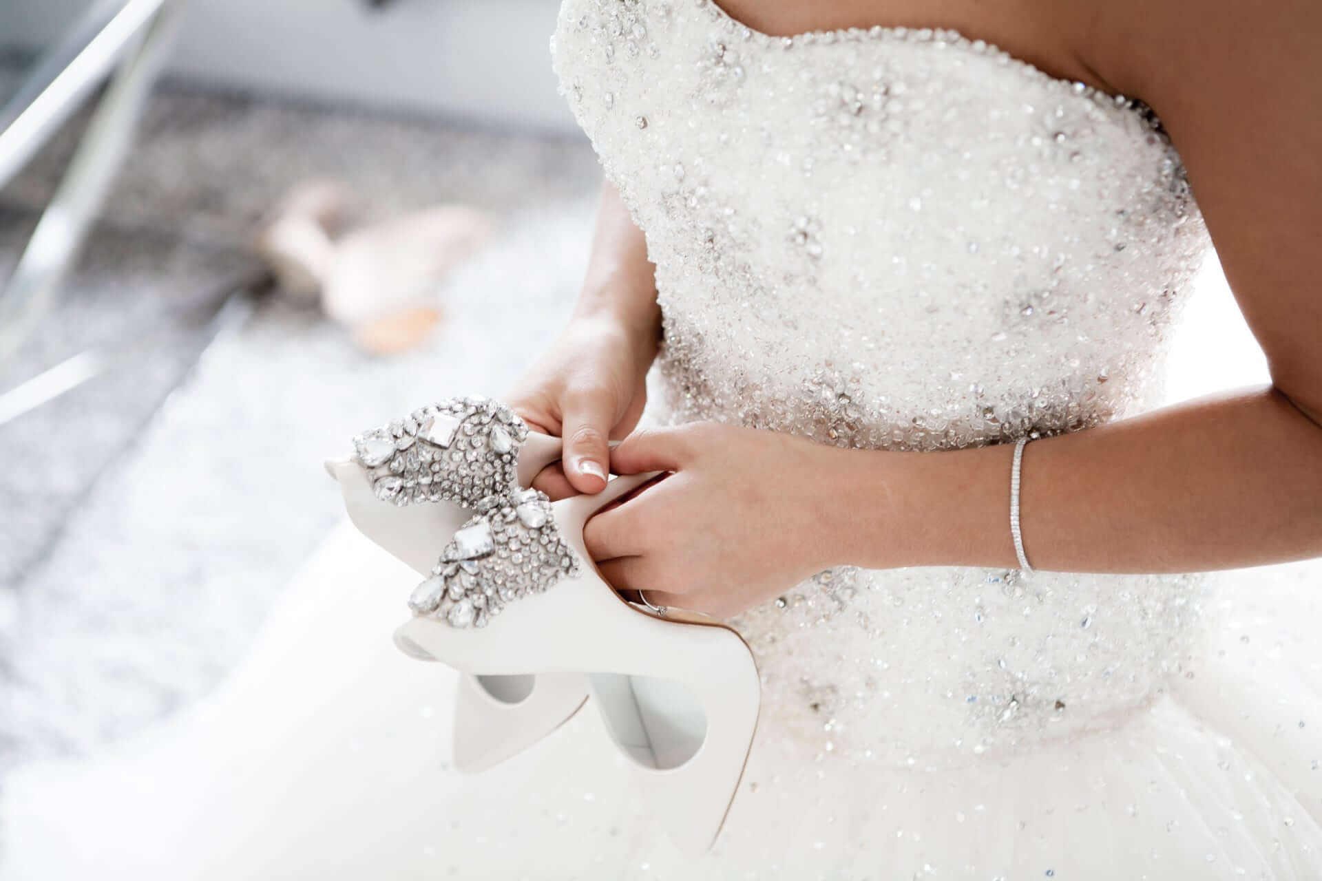 Bride Dressed In Her Dress With White Shoes In Her Hands - Front Page Gay Wedding Guide