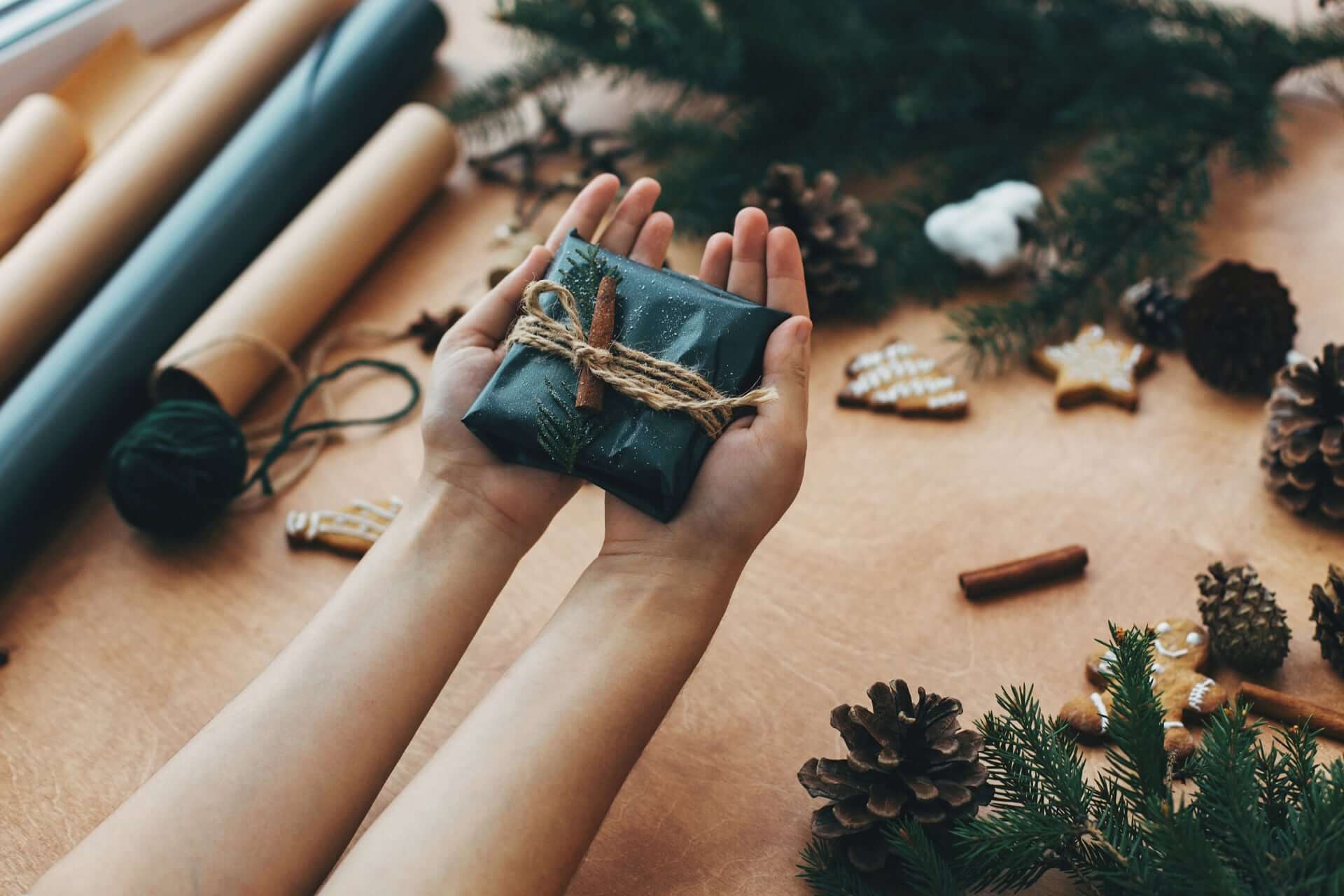 Hands Giving Rustic Christmas Gift In Black Wrappi Bnn72Vc 2 - What To Consider When Buying Groomsmen Gifts Hands Giving Rustic Christmas Gift In Black Wrappi Bnn72Vc 2 - What To Consider When Buying Groomsmen Gifts Gay Wedding Guide