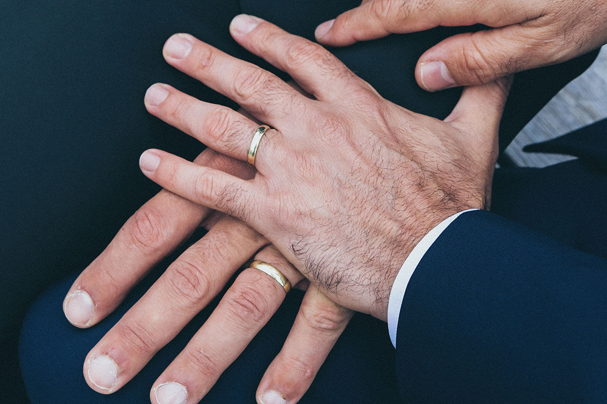 Two Men Hands Wearing Gold Colored Wedding Rings By Nick Karvounis From Unsplash Via Gay Wedding Guide 2 - Top 10 Same-Sex Destination Weddings And Honeymoons That Will Make You Pop The Question Today Gay Wedding Guide