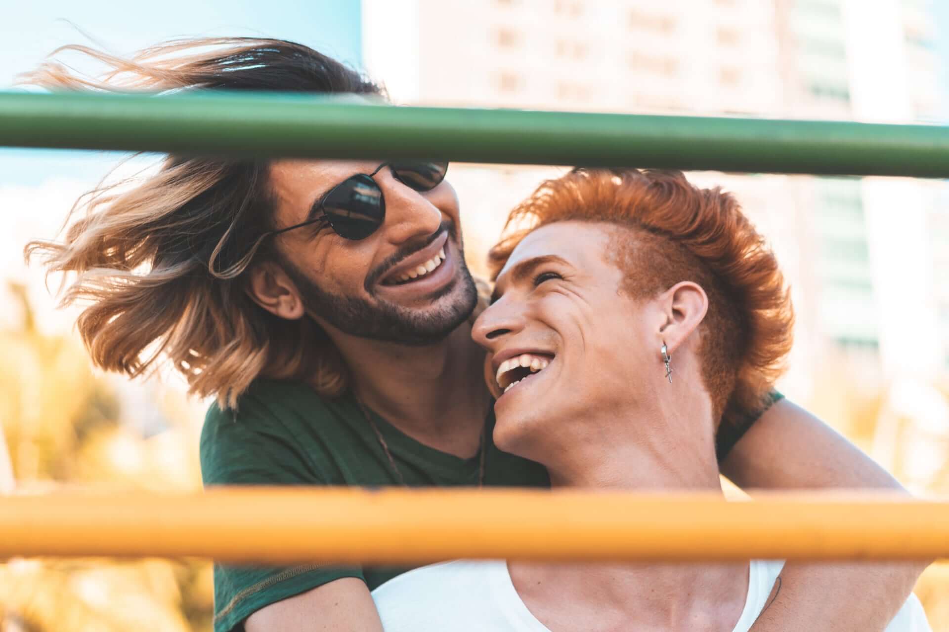 Young Gay Couple Hugging And Smiling At Each Other 2 - How To Choose An Elopement Photographer Young Gay Couple Hugging And Smiling At Each Other 2 - How To Choose An Elopement Photographer Gay Wedding Guide