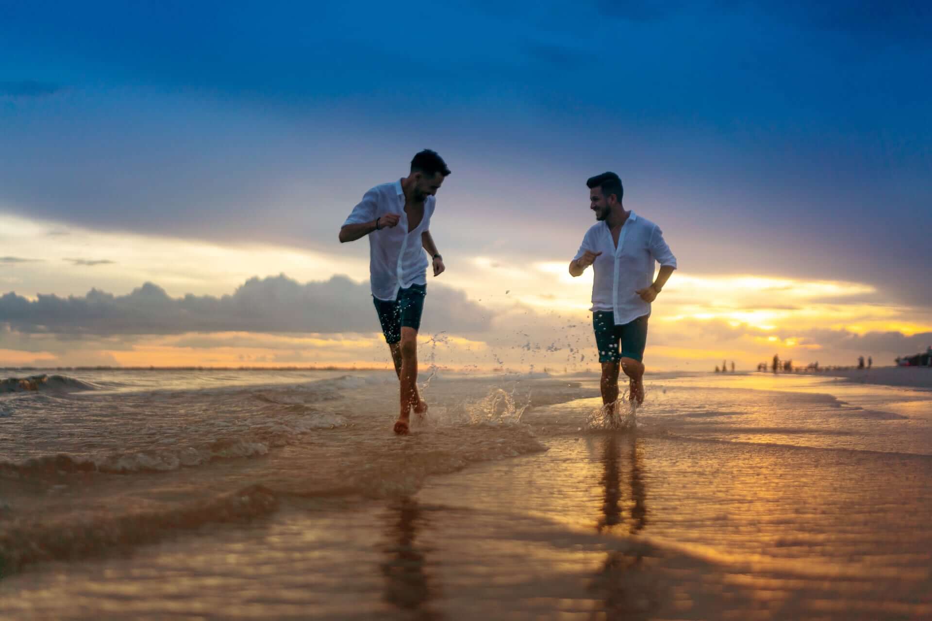 Young Gay Couple Running On Empty Beach Florida 2 - How To Choose An Elopement Photographer Young Gay Couple Running On Empty Beach Florida 2 - How To Choose An Elopement Photographer Gay Wedding Guide