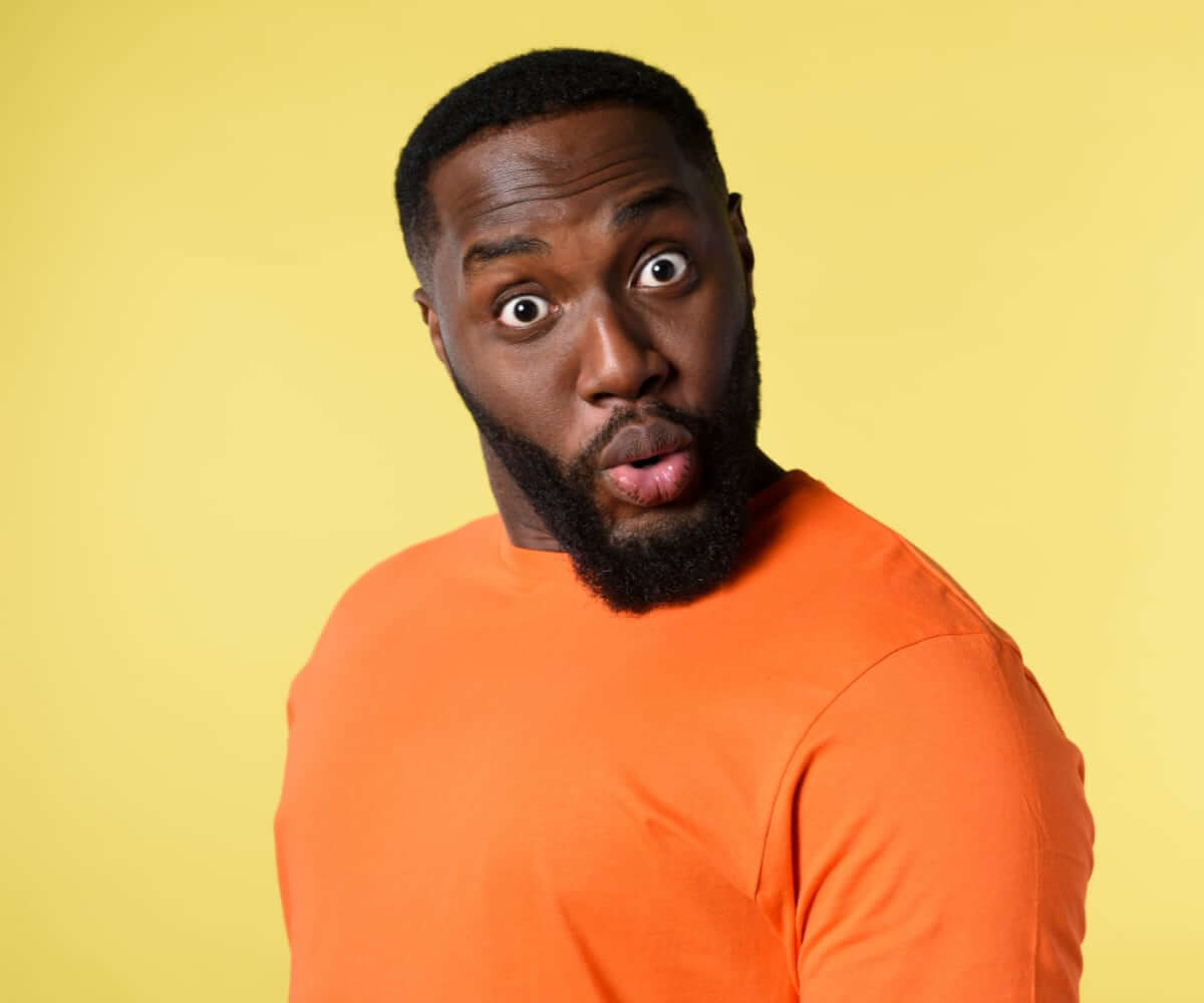 Black-Man-With-Surprised-And-Amazed-Expression.-Yellow-Background Black Man With Surprised And Amazed Expression. Yellow Background - Advertorials Gay Wedding Guide
