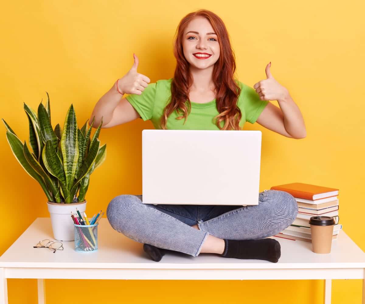 Happy-Excited-Lady-Wearing-Green-T-Shirt-And-Jeans-Sitting-On-Table-With-Laptop-On-Knees Happy Excited Lady Wearing Green T Shirt And Jeans Sitting On Table With Laptop On Knees - Advertorials Gay Wedding Guide