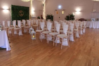 Indoor Wedding Ceremony With A Flower Wall