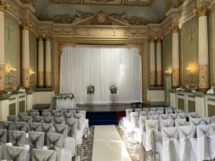 Craig Y Nos Castle Ceremony Room With White Screen White Chair And Silver Chair Covers 01 306X230